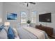 Comfortable main bedroom featuring a TV, neutral decor, and windows for natural light at 502 E Robles St, Tampa, FL 33602