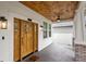 Inviting covered porch featuring wood ceiling, a stylish fan, and striking double front door at 502 E Robles St, Tampa, FL 33602
