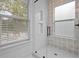 Close-up of glass shower with white tile, shower niche and decorative accent wall at 502 E Robles St, Tampa, FL 33602