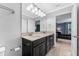 Bathroom with large mirror, double vanity, and a view into the bedroom at 5153 Bay Isle Cir, Clearwater, FL 33760