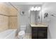 Bathroom with single vanity, combined shower and tub and beige tile at 5153 Bay Isle Cir, Clearwater, FL 33760