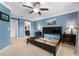 Light blue bedroom features a ceiling fan, two dressers and decor on the wall at 5153 Bay Isle Cir, Clearwater, FL 33760