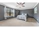 Bedroom with large window, ceiling fan, and carpet flooring throughout at 5153 Bay Isle Cir, Clearwater, FL 33760
