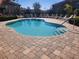 Inviting community pool with stone pavers, clear blue water, and lounge seating nearby at 5153 Bay Isle Cir, Clearwater, FL 33760