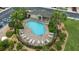 Aerial view of a sparkling community pool surrounded by lounge chairs and lush landscaping at 5153 Bay Isle Cir, Clearwater, FL 33760