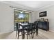 Bright dining area with a large window offering a view of the outdoor scenery at 5153 Bay Isle Cir, Clearwater, FL 33760