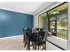Relaxing dining area featuring access to screened patio with views of the pond at 5153 Bay Isle Cir, Clearwater, FL 33760