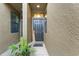 Front entrance featuring a black front door and a welcome sign with a tropical plant at 5153 Bay Isle Cir, Clearwater, FL 33760
