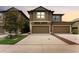 Two-story townhome featuring a two-car garage and neutral-toned exterior paint at dusk at 5153 Bay Isle Cir, Clearwater, FL 33760