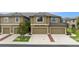Townhome exterior with attached garages, neutral paint and manicured lawn at 5153 Bay Isle Cir, Clearwater, FL 33760
