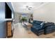 Inviting living room with view of dining area, fireplace, and a comfortable blue sofa at 5153 Bay Isle Cir, Clearwater, FL 33760