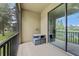 Cozy screened-in patio with outdoor seating overlooking a lush green space at 5153 Bay Isle Cir, Clearwater, FL 33760