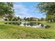 Scenic pond with a fountain as a focal point, surrounded by manicured lawns and trees at 5153 Bay Isle Cir, Clearwater, FL 33760
