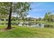 Scenic pond with a fountain as a focal point, surrounded by manicured lawns and trees at 5153 Bay Isle Cir, Clearwater, FL 33760