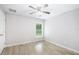 A bedroom featuring hardwood floors, a window, and a ceiling fan at 5319 Lantana St, Zephyrhills, FL 33542