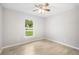 Cozy bedroom with tile flooring and a window offering natural light at 5319 Lantana St, Zephyrhills, FL 33542