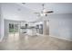 Open kitchen and living area with stainless steel appliances and access to patio at 5319 Lantana St, Zephyrhills, FL 33542