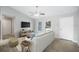 Bright living room with wood-look tile flooring, ceiling fan, and a comfortable sofa with stylish decor at 5319 Lantana St, Zephyrhills, FL 33542