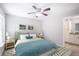 Cozy bedroom featuring a comfortable bed with blue accents, neutral walls, and stylish decor at 5319 Lantana St, Zephyrhills, FL 33542