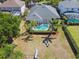 An aerial view of the backyard, showcasing a screened-in pool, a seating area, and a playground at 5813 Bent Grass Dr, Valrico, FL 33596