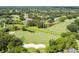 Aerial view of a golf course community featuring lush green fairways, ponds, and beautiful homes surrounded by trees at 5813 Bent Grass Dr, Valrico, FL 33596