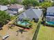 Aerial shot of the home with a screened-in pool, lush landscaping, and a spacious yard offering outdoor enjoyment at 5813 Bent Grass Dr, Valrico, FL 33596