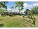 Expansive backyard with a playset, lawn chairs, and screened-in patio, perfect for outdoor enjoyment and relaxation at 5813 Bent Grass Dr, Valrico, FL 33596
