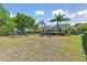 Expansive backyard with mature trees, recreational equipment, screened in pool, and plenty of space for outdoor activities at 5813 Bent Grass Dr, Valrico, FL 33596
