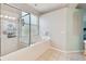 Bathroom featuring a shower and tub combo with glass enclosure and a built-in niche at 5813 Bent Grass Dr, Valrico, FL 33596