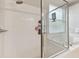 Close up of a glass enclosed shower and tub combo featuring a built-in niche and overhead shower head at 5813 Bent Grass Dr, Valrico, FL 33596