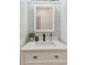 Close-up of the bathroom vanity with a white countertop, modern fixtures, and decor creating a fresh, clean aesthetic at 5813 Bent Grass Dr, Valrico, FL 33596