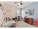 Whimsical bedroom with fan, desk and Stitch themed decor and pink and blue color scheme at 5813 Bent Grass Dr, Valrico, FL 33596