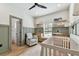 Inviting Bedroom featuring board and batten accent wall, rocker, crib, and wood shelves at 5813 Bent Grass Dr, Valrico, FL 33596