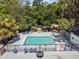 Inviting community pool area with ample seating, mature trees, and a tranquil setting for relaxation and recreation at 5813 Bent Grass Dr, Valrico, FL 33596