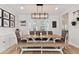 An open concept dining area featuring wood floors, a long table, and a decorative light fixture at 5813 Bent Grass Dr, Valrico, FL 33596