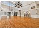 Well lit hall with tall ceilings, wood floors, decorative lighting, and large windows overlooking outdoor greenery at 5813 Bent Grass Dr, Valrico, FL 33596