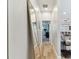 Light-filled hallway leads to open concept living with beautiful hardwood flooring at 5813 Bent Grass Dr, Valrico, FL 33596