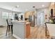 Open concept kitchen provides seating at the breakfast bar, stainless appliances, and a view to the dining area at 5813 Bent Grass Dr, Valrico, FL 33596