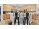 Well-lit kitchen features stainless appliances, lots of cabinets, and breakfast bar with seating for two at 5813 Bent Grass Dr, Valrico, FL 33596