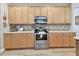 Charming kitchen offers stainless steel appliances, beautiful wood cabinets, and light countertops at 5813 Bent Grass Dr, Valrico, FL 33596