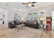 Bright living room boasts light wood floors, French doors, neutral color palette, ceiling fan, and comfortable furnishings at 5813 Bent Grass Dr, Valrico, FL 33596
