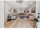 A spacious living room with wood floors, gray sofas, a dark ottoman, and decoratively adorned white walls at 5813 Bent Grass Dr, Valrico, FL 33596