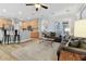 Living room with bar seating overlooking open kitchen and dark grey sofa in front of french doors to dining area at 5813 Bent Grass Dr, Valrico, FL 33596