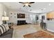 Open floorplan with living, dining and kitchen showcasing hardwood floors, ceiling fan, and neutral paint at 5813 Bent Grass Dr, Valrico, FL 33596