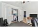Office with an open closet, desk, weights, exercise equipment and wood laminate floors at 5813 Bent Grass Dr, Valrico, FL 33596