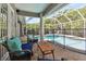 Charming covered patio with comfortable seating overlooking the pool area, offering a relaxing outdoor living space at 5813 Bent Grass Dr, Valrico, FL 33596