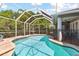 Beautiful pool featuring a screened enclosure, surrounding patio, and well-maintained landscaping for privacy and enjoyment at 5813 Bent Grass Dr, Valrico, FL 33596