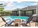 Relaxing poolside view with comfortable patio chairs and serene water, ideal for leisure and entertaining guests at 5813 Bent Grass Dr, Valrico, FL 33596