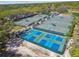 Aerial view of well-maintained tennis and pickleball courts within a green community setting, offering recreation options at 5813 Bent Grass Dr, Valrico, FL 33596