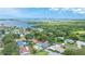 Stunning aerial view showcasing the property's location near the water and lush surroundings, complemented by a private pool at 5871 Oakhurst Dr, Seminole, FL 33772